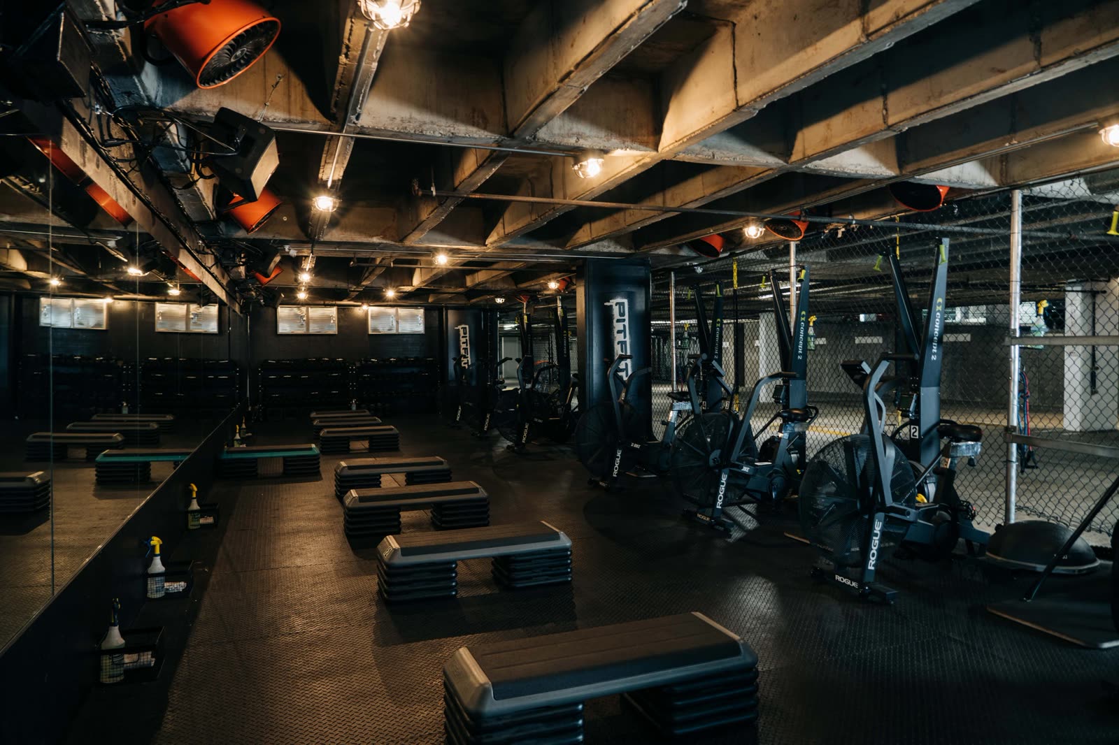 Inside the PITFIT studio — steps, air bikes and the strength floor in the Travis Walk parking garage